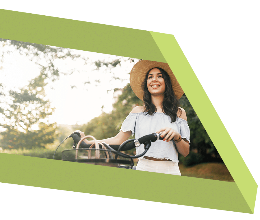 Smiling young woman with bike outdoors